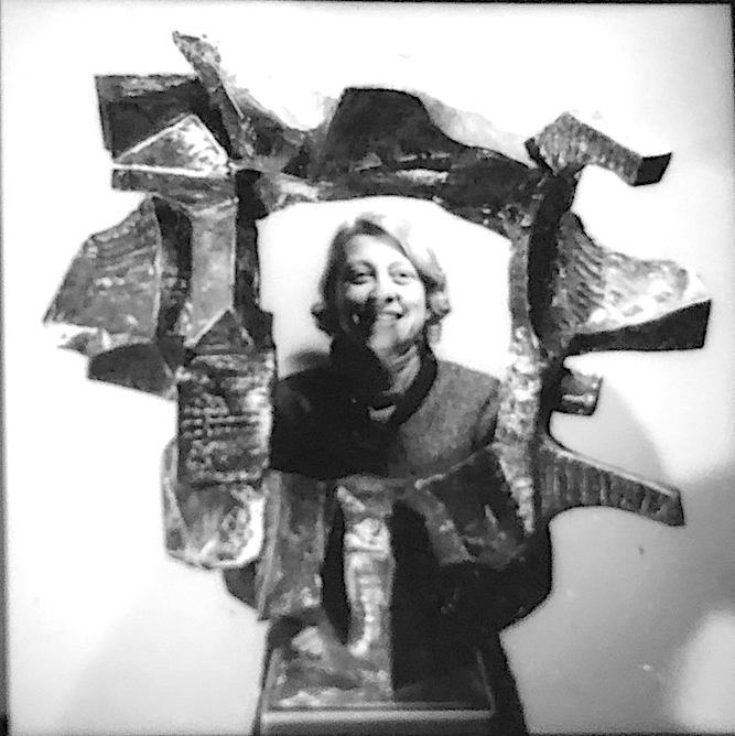 Kreilick with her bronze sculpture “Farbenform”, c.1979-80, collection of Flint Institute of Arts